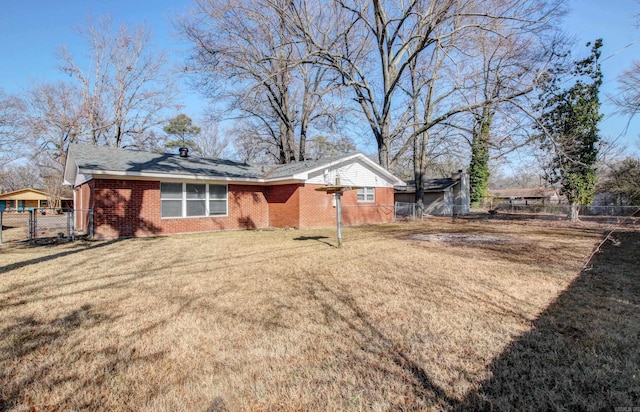 rear view of property featuring a yard