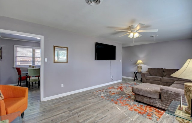 living room featuring ceiling fan and hardwood / wood-style floors