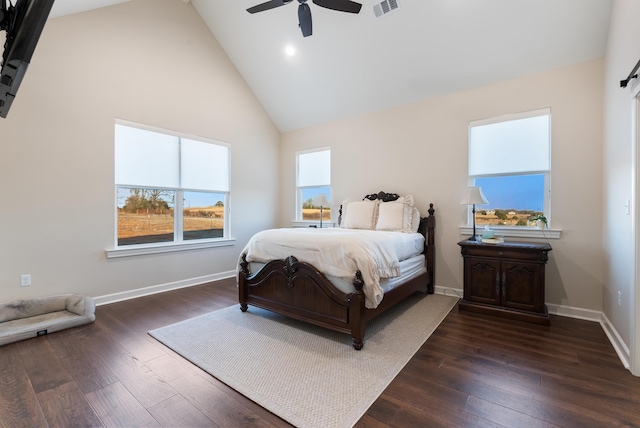 bedroom with dark wood-type flooring, ceiling fan, and high vaulted ceiling