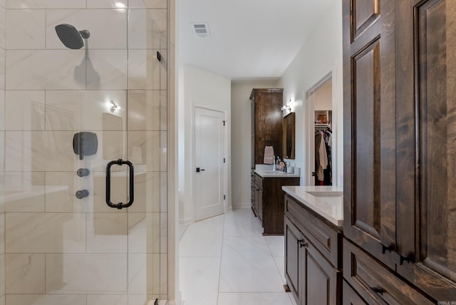 bathroom featuring vanity and a shower with shower door