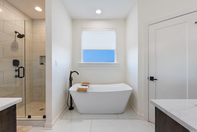 bathroom featuring vanity and independent shower and bath