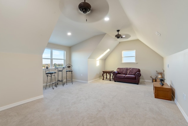 additional living space with vaulted ceiling, light colored carpet, and ceiling fan
