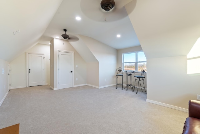 additional living space with ceiling fan, lofted ceiling, and light carpet