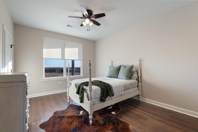 bedroom with ceiling fan and dark hardwood / wood-style flooring
