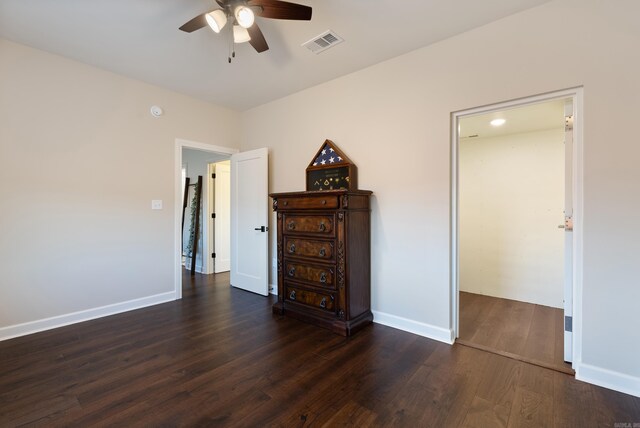 unfurnished bedroom with dark hardwood / wood-style flooring and ceiling fan