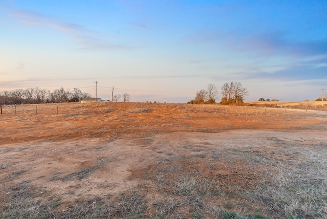 yard at dusk with a rural view