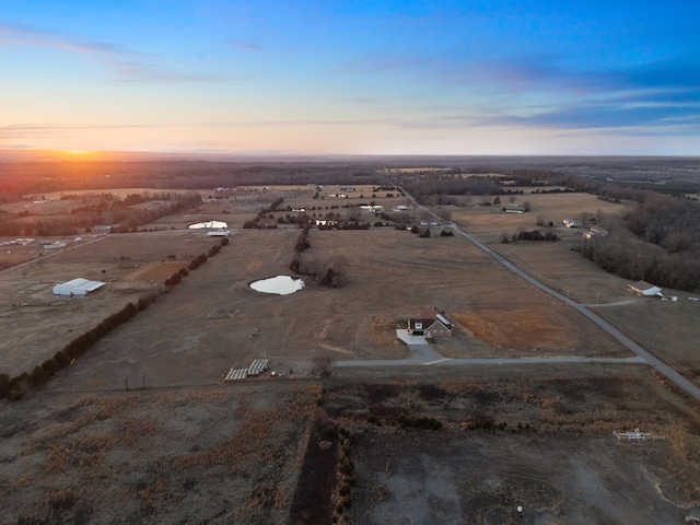 aerial view at dusk featuring a rural view