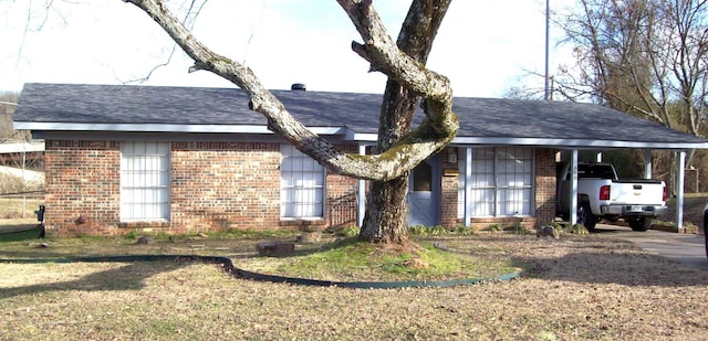 single story home with a carport and a front lawn