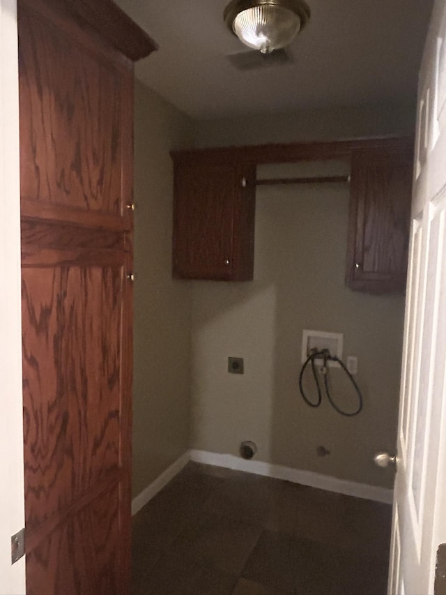 laundry room with electric dryer hookup, hookup for a washing machine, and cabinets