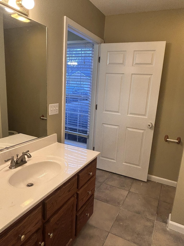 bathroom with vanity and tile patterned floors