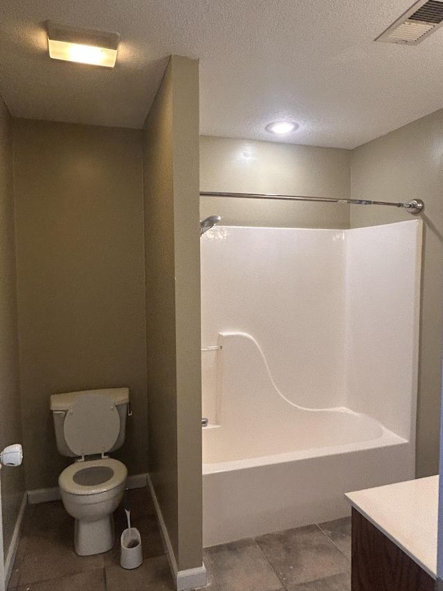 full bathroom with  shower combination, tile patterned flooring, vanity, a textured ceiling, and toilet