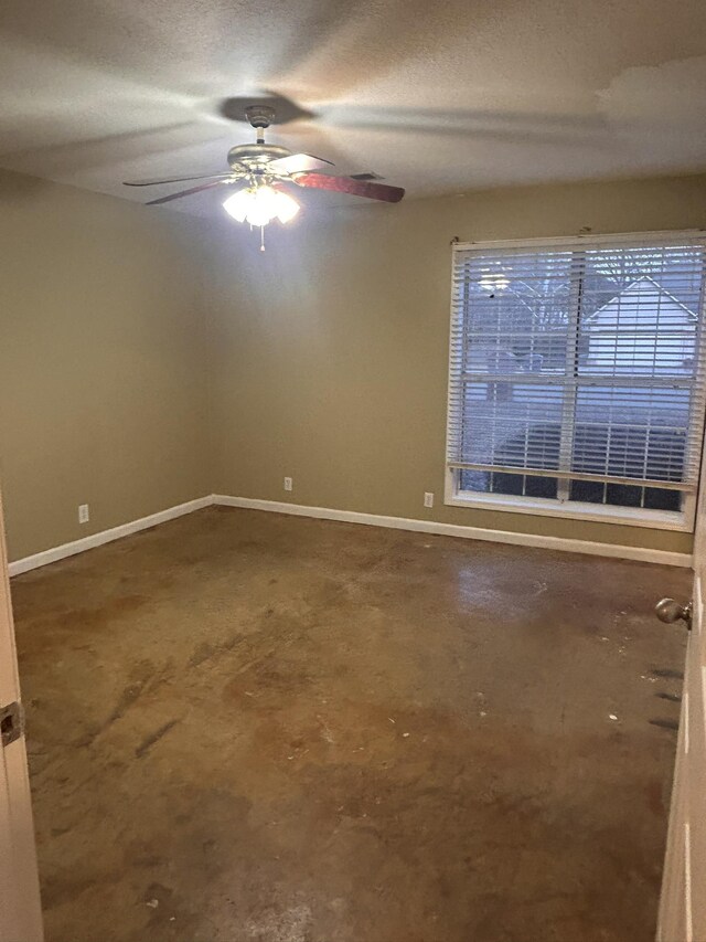 unfurnished room featuring ceiling fan and a textured ceiling