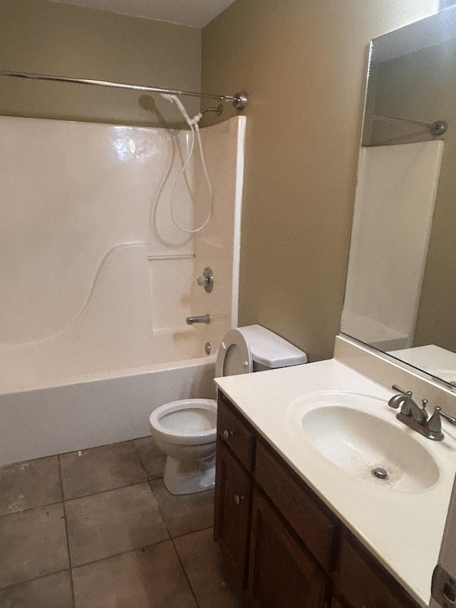 full bathroom with shower / tub combination, vanity, tile patterned floors, and toilet