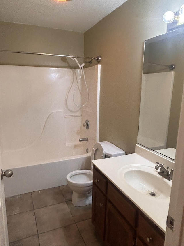 full bathroom featuring tile patterned flooring, vanity, shower / bathing tub combination, a textured ceiling, and toilet