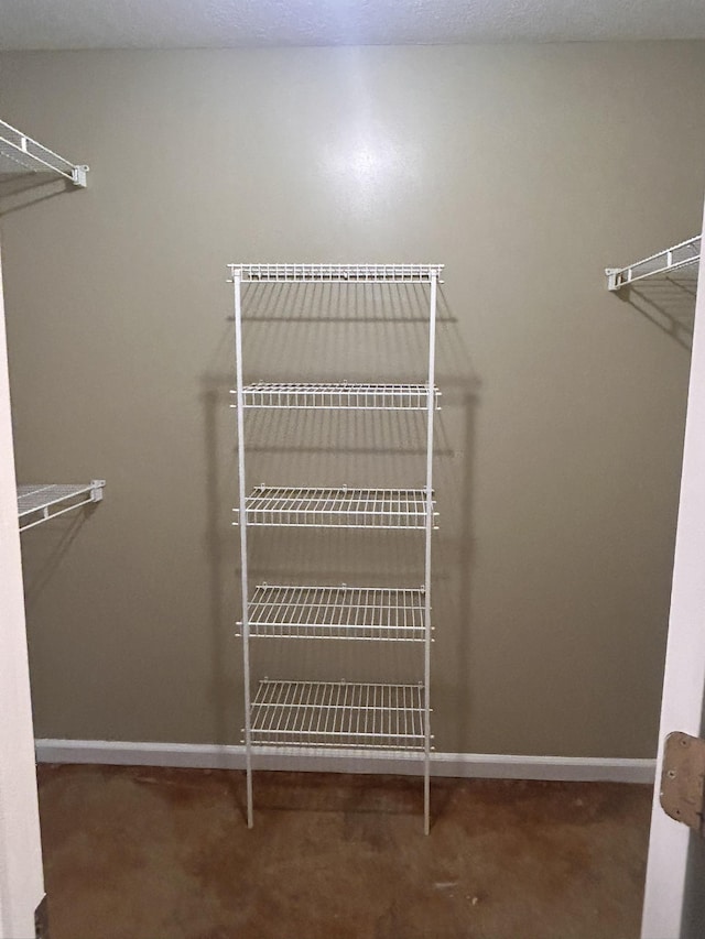 spacious closet featuring dark carpet