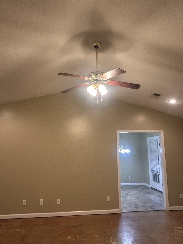 empty room featuring vaulted ceiling and ceiling fan