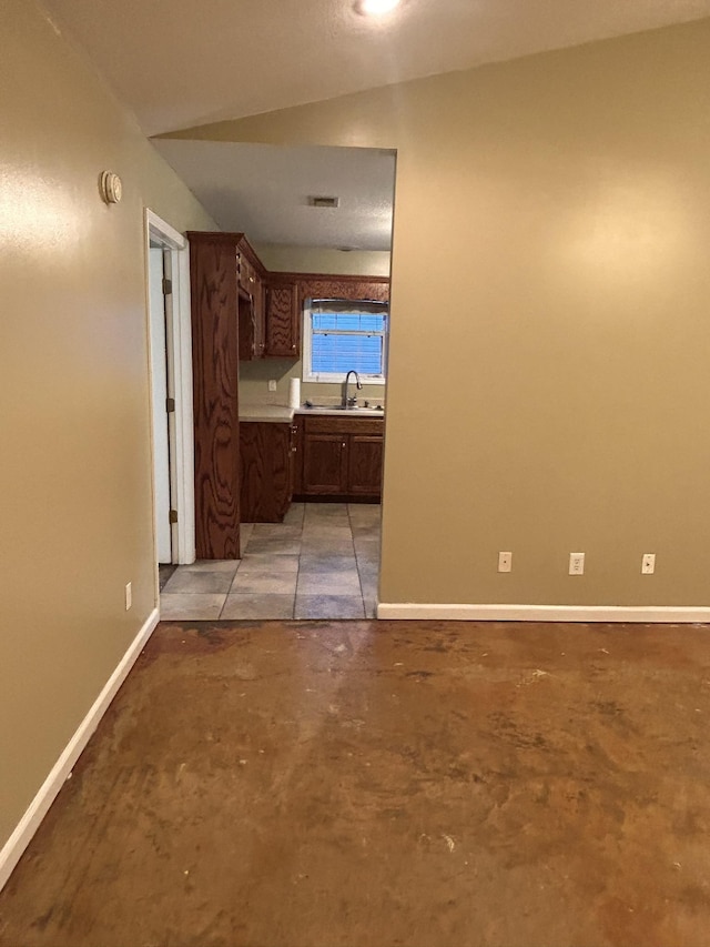 hallway with sink and vaulted ceiling