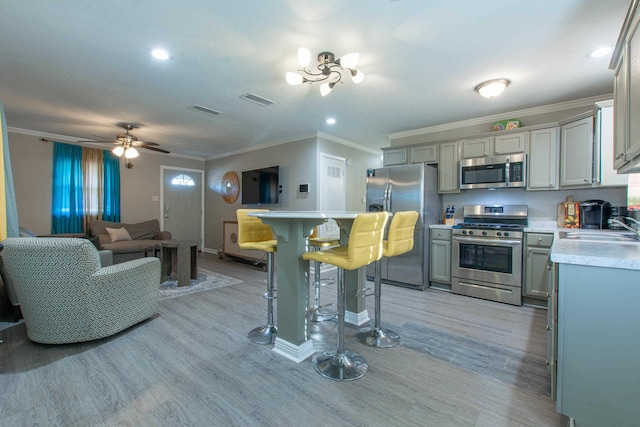 kitchen featuring sink, gray cabinets, light hardwood / wood-style floors, and appliances with stainless steel finishes