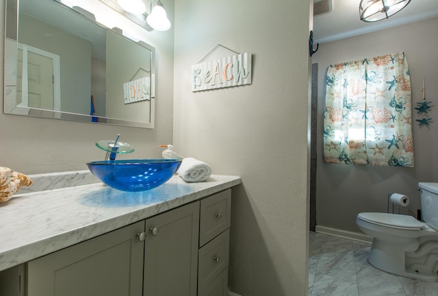 bathroom with vanity and toilet