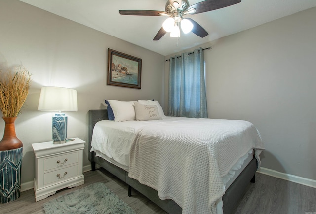 bedroom with ceiling fan and dark hardwood / wood-style flooring