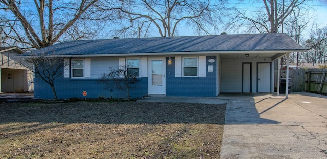 ranch-style house featuring a carport and a front lawn