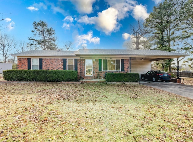 ranch-style house with a carport and a front yard