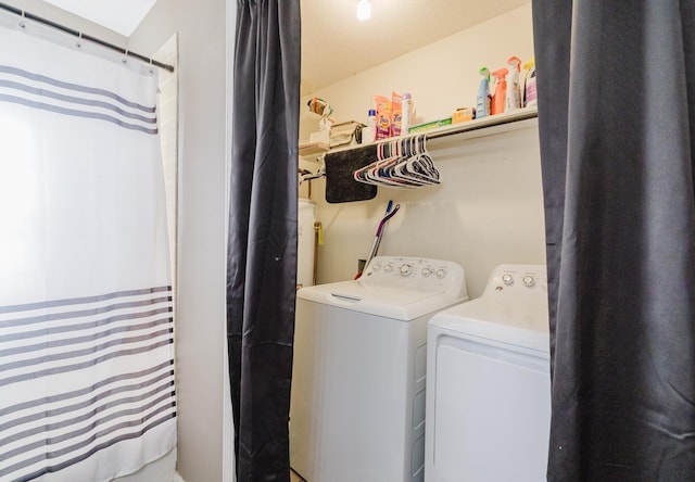 laundry area featuring washing machine and clothes dryer