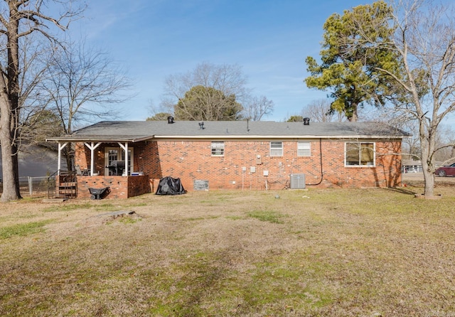 back of property featuring a yard and central air condition unit