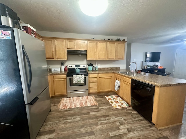 kitchen with extractor fan, sink, dark hardwood / wood-style flooring, kitchen peninsula, and stainless steel appliances