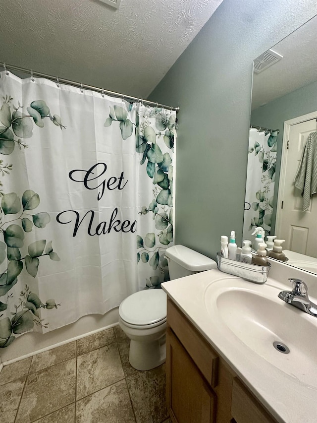 bathroom with vanity, a textured ceiling, and toilet