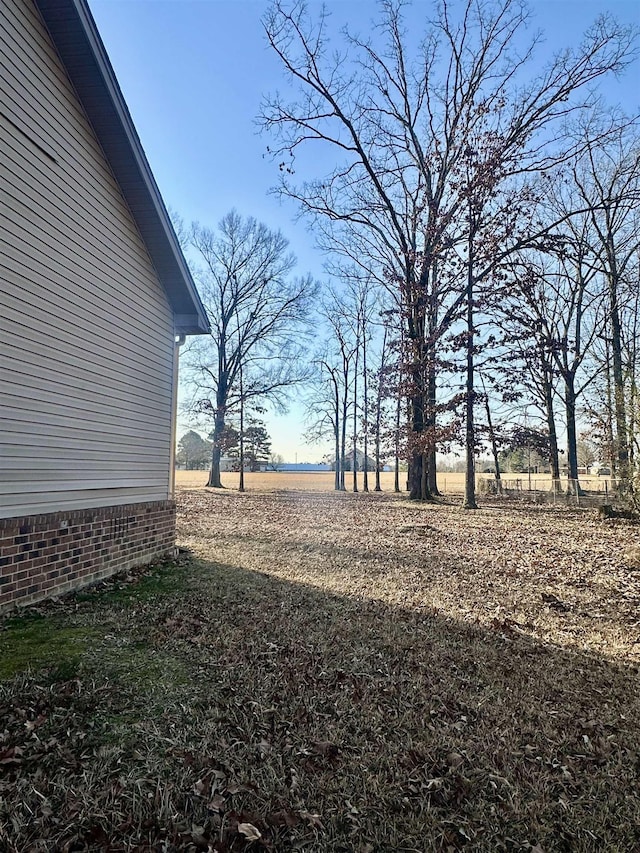 view of yard with a rural view