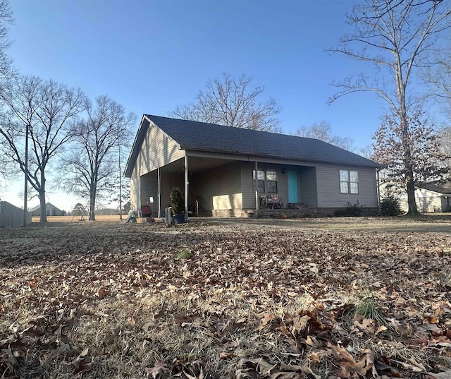 view of side of home with a carport