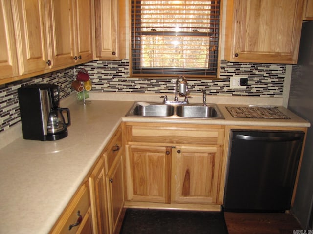 kitchen with tasteful backsplash, sink, and black dishwasher