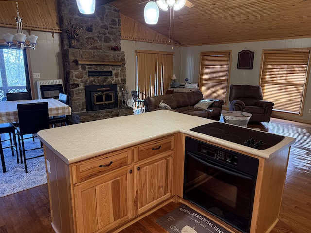 kitchen featuring dark hardwood / wood-style floors, heating unit, a fireplace, black appliances, and wooden ceiling