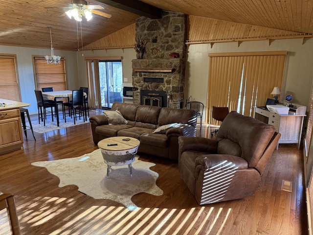 living room with lofted ceiling with beams, dark hardwood / wood-style floors, ceiling fan with notable chandelier, and wood ceiling