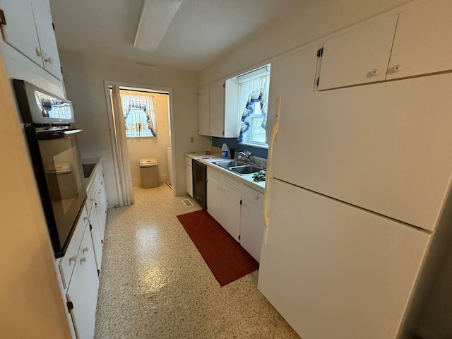 kitchen with white cabinetry, sink, and black appliances