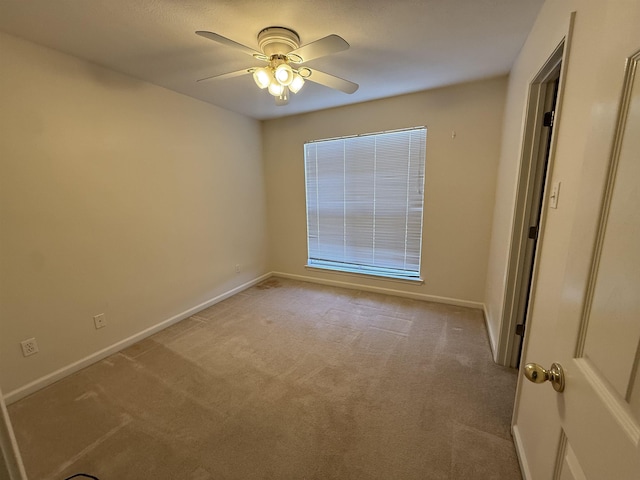 carpeted spare room with ceiling fan