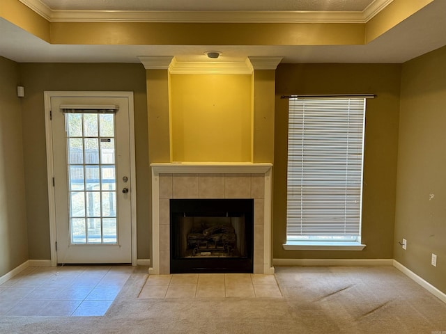 unfurnished living room featuring light carpet, plenty of natural light, a tile fireplace, and a raised ceiling