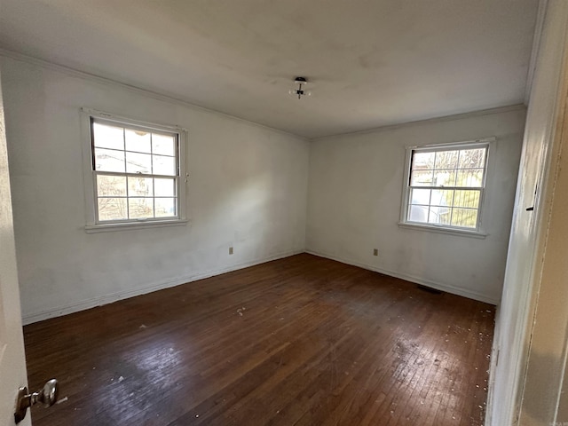 unfurnished room with ornamental molding and dark hardwood / wood-style flooring