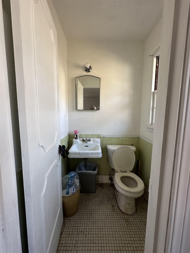 bathroom featuring tile patterned flooring, sink, and toilet