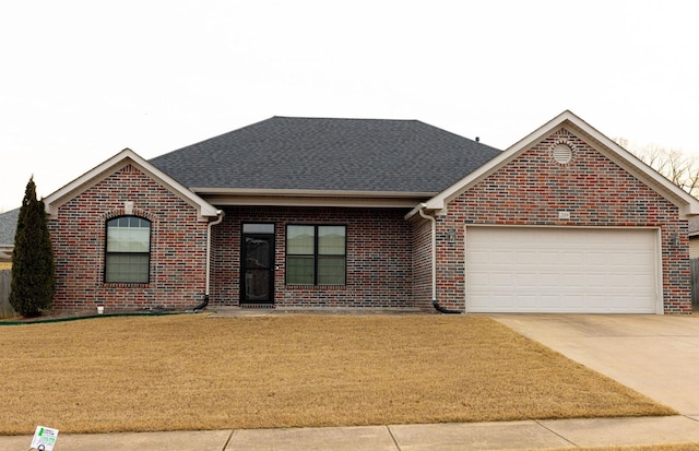 single story home featuring a garage and a front lawn