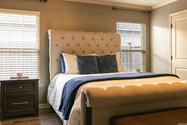 bedroom with crown molding and dark hardwood / wood-style floors