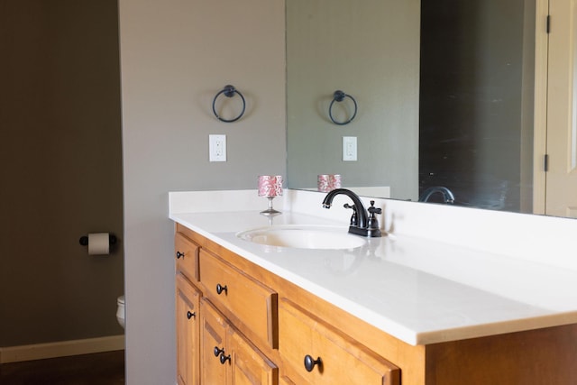 bathroom featuring vanity and toilet