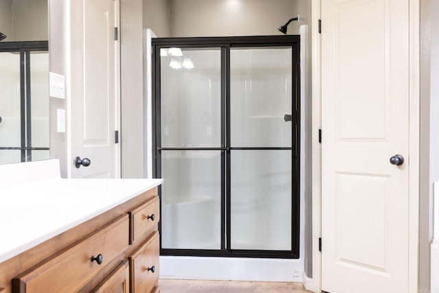 bathroom with an enclosed shower and vanity