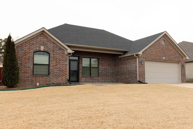 ranch-style house with a garage and a front lawn