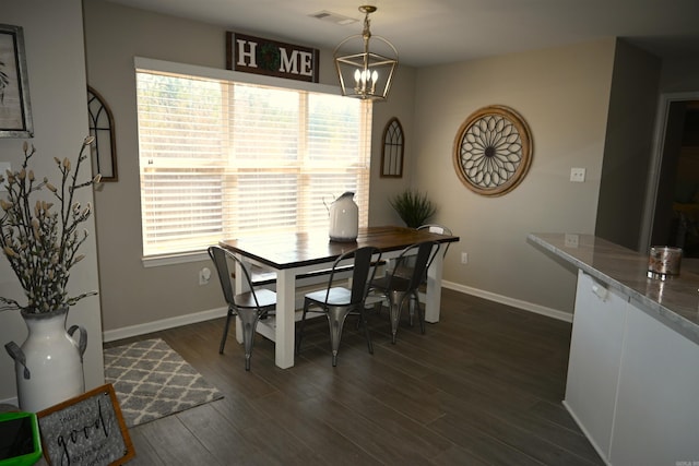 dining room with a notable chandelier and dark hardwood / wood-style floors