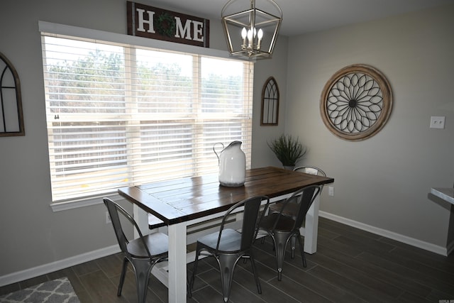 dining room featuring a healthy amount of sunlight, an inviting chandelier, and dark hardwood / wood-style flooring