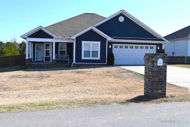 view of front of house featuring a garage and a porch