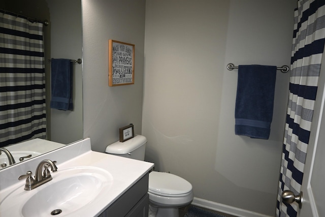 bathroom with vanity, walk in shower, and toilet