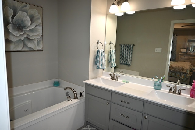 bathroom with vanity and a tub to relax in